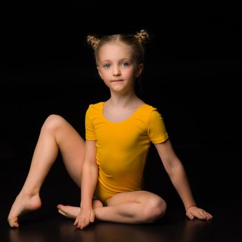 Beautiful blue eyed girl gymnast in yellow leotard