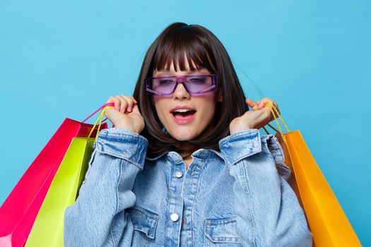 beautiful woman in sunglasses shopping emotions posing joy blue background