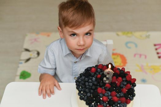 Boy blows out the candles for his birthday