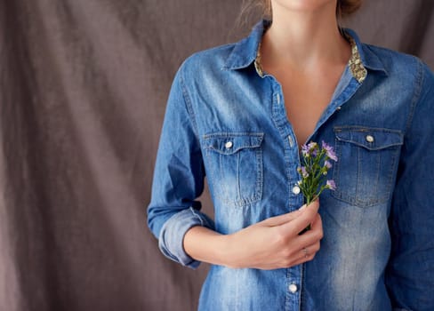 Cropped shot of a woman holding cut flowers