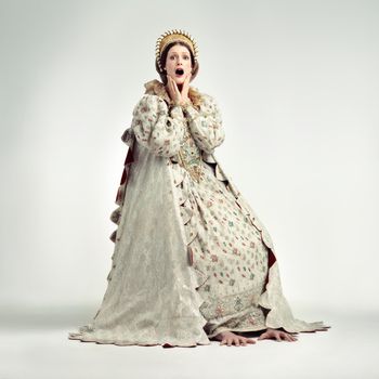 The peasants are revolting. Studio shot of young queen gasping in surprise.