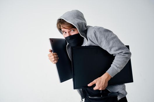 masked man hooded head hacking technology security light background