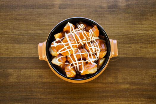 Plate of patatas bravas, a typical Spanish dish, on restaurant table