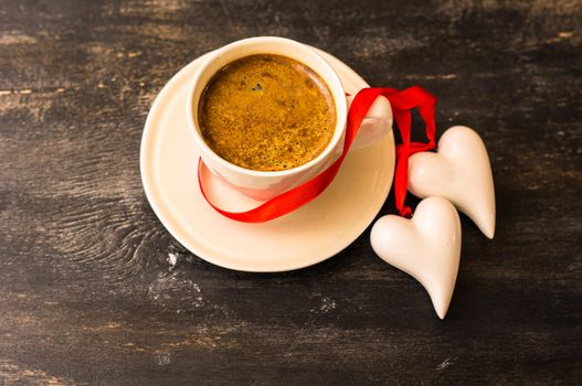 Cup of coffee with heart shaped gifts