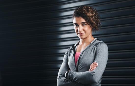 Focused on my healthy goals. Cropped portrait of an attractive young woman standing against a black background in her workout clothes before exercising.