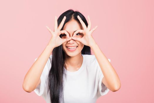 woman standing, She made finger OK symbol sign to agree near eyes