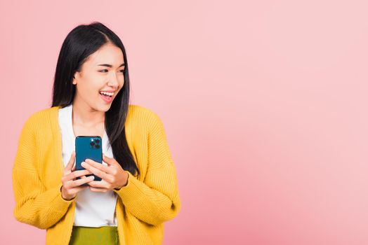 woman teen smiling excited   using smart mobile phone