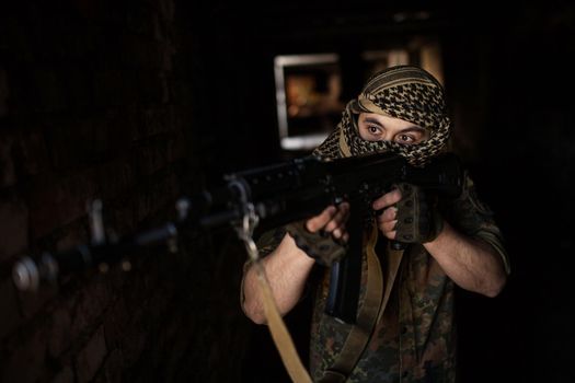 Arab soldier aiming with Kalashnikov AK-47 assault rifle