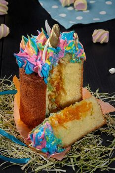 Sliced Easter cake with whipped egg whites in shape of unicorn