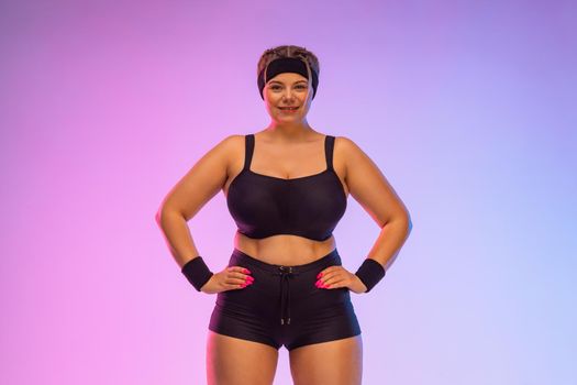 Fat woman in gym. Body positive and fitness concept.