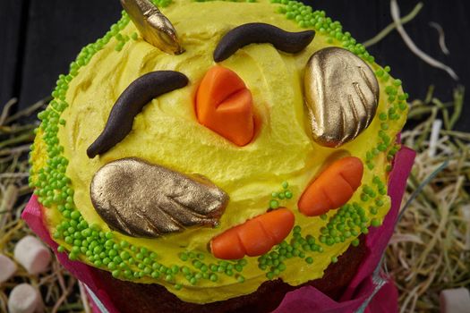 Yellow whipped egg whites in shape of chicken on Easter cake