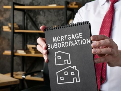 Manager showing black page with inscription Mortgage subordination.