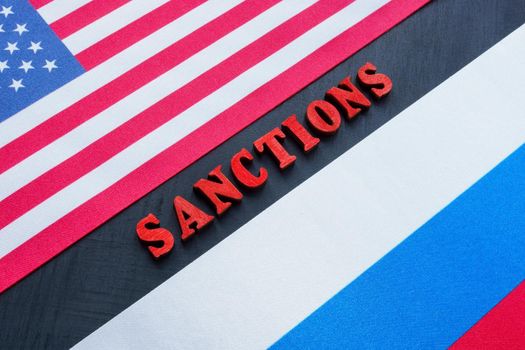 Word Sanctions and flag of USA and Russia.