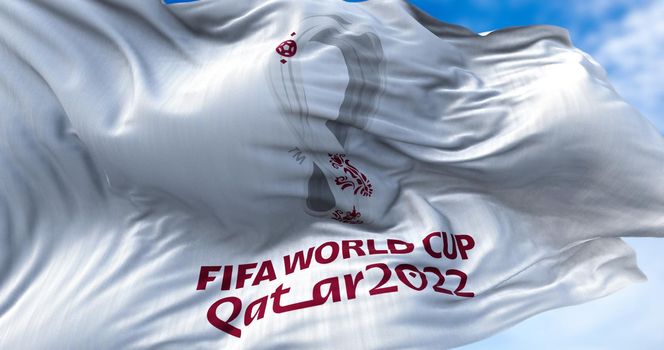 Doha, Qatar, October 2021: Flag with the 2022 Fifa World Cup logo flapping in the wind