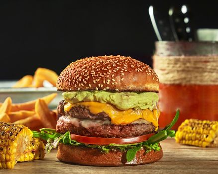 Mexican cheeseburger with two patties, guacamole, tomato and greens