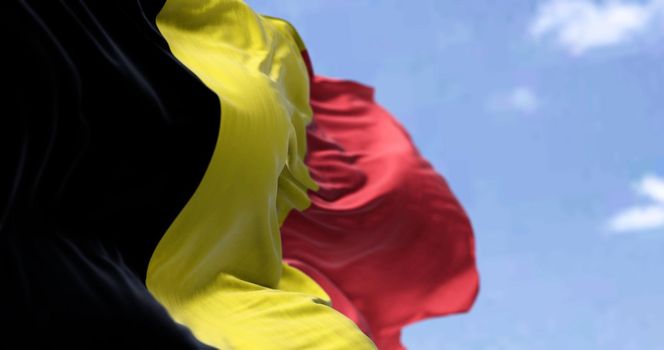 Detail of the national flag of Belgium waving in the wind on a clear day