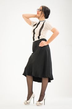 Studio photo of middle aged woman starting getting grey-haired wearing black and white clothes on white background, middle age sexy lady, happy life concept