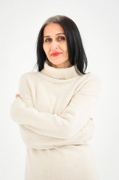 Middle aged woman starting getting grey-haired is posing in studio in sweater on white background, face skin care beauty, middle age skincare cosmetics, cosmetology concept
