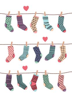 Funny socks in different colors hanging on ropes