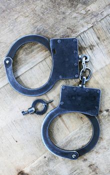 Handcuffs On Wood
