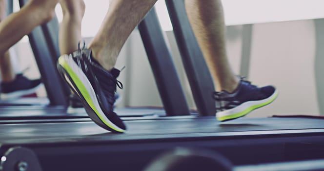 Treadmills are so underrated. Close-up 4k video of people working out on a treadmill at the gym.