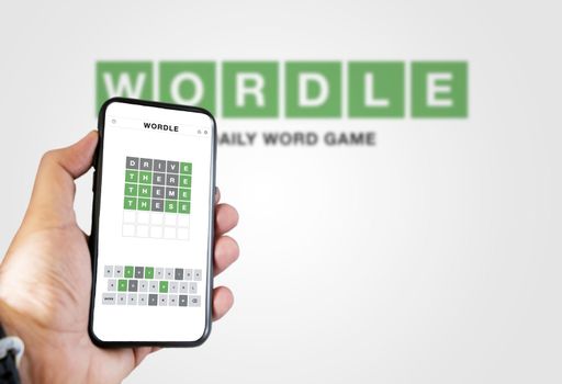 Rome, Italy, January 2022: Hand holding a phone with Wordle game running