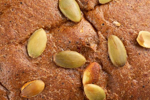 Closeup on pumpkin seeds bread texture background