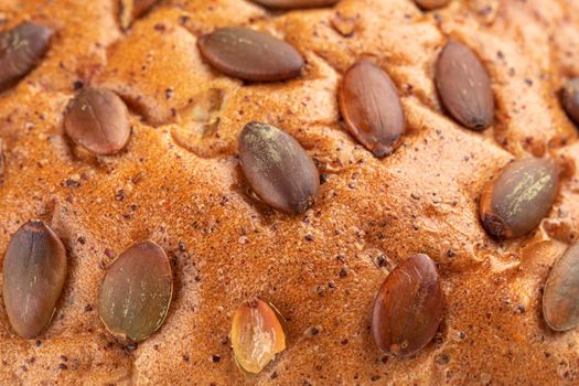 Closeup on pumpkin seeds bread texture background