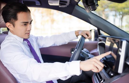 Handsome young Man using navigation system while driving car