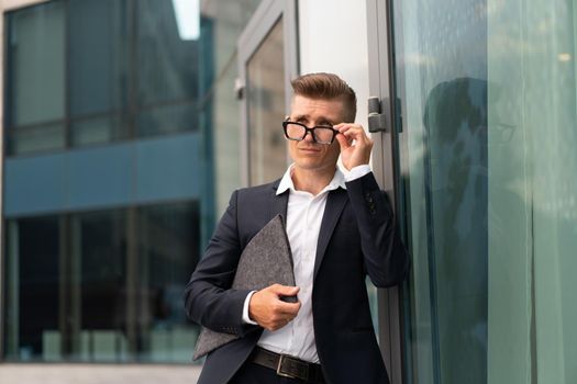 Business. Businessman Glasses With Folder Standing Office Building Entrance Handsome Caucasian Male Business Person Portrait City Corporative Building Background Successful Young Adult Manager