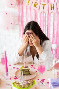 Beautiful excited woman celebrating birthday party making wish