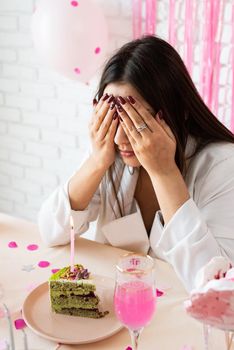Beautiful excited woman celebrating birthday party making wish