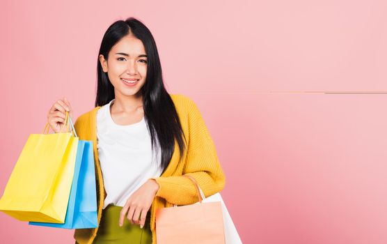 woman teen shopper smiling standing excited holding online shopping bags