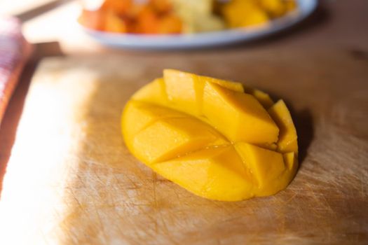 Close-up of diced mango on wooden cutting board