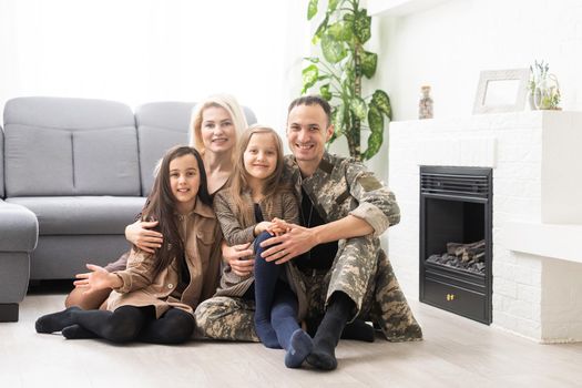 Joyful happy military man with his wife and two kids. Family togetherness and support concept