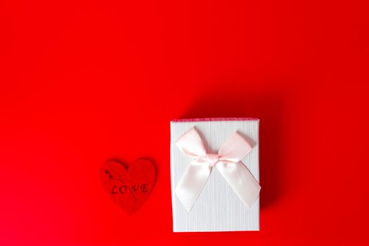 Gift box on red background. Romantic st. Valentine's day concept of greetings. place for your text