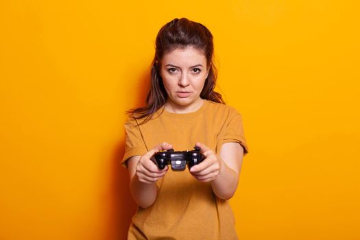 Portrait of woman holding controller in front of camera