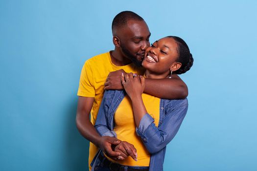African american couple smiling and hugging each other