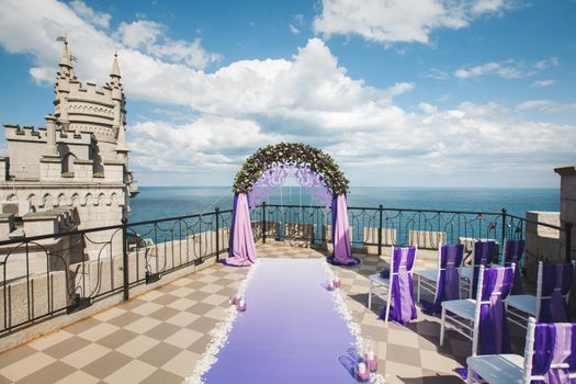Wedding arch of purple color on the background of the sea