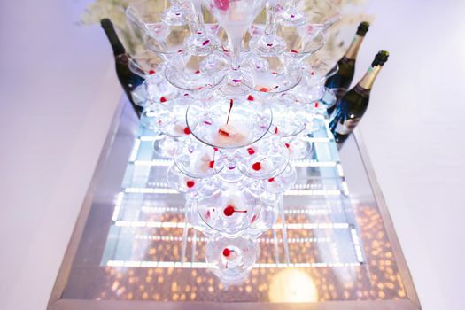 Pyramid of glasses, cherry in the glass.