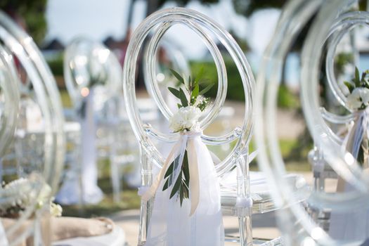 White transparent chairs at the wedding ceremony.