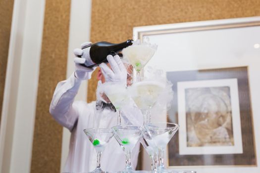 A waiter pours alcohol into glasses at a Banquet
