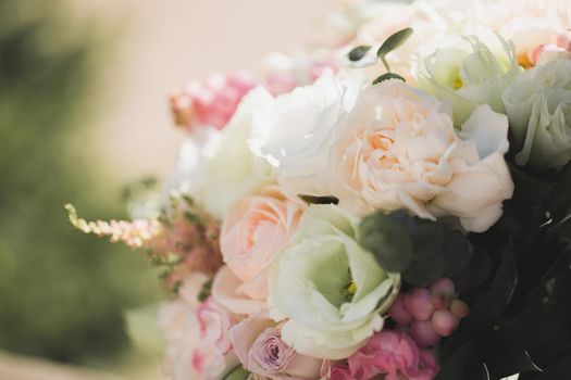 A luxurious delicate wedding bouquet of roses and eustom close-up