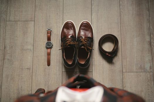 Stylish men's plaid suit and brown shoes, watch and groom's belt.