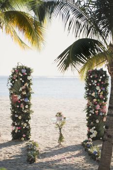 Wedding arch on the beach on the background of the ocean