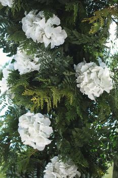 Wedding decor made of green branches and white flowers