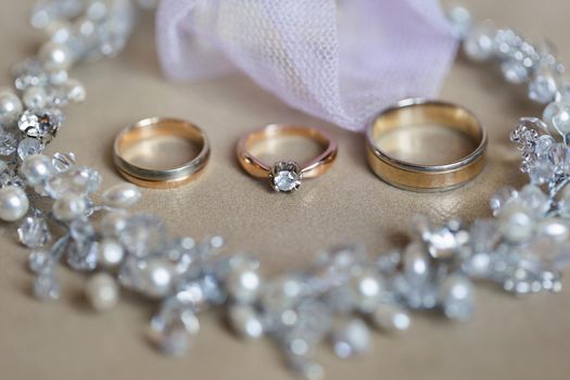 Gold wedding rings and necklace. Wedding accessories