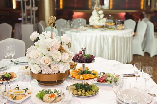 Served wedding banquet table with dishes in the restaurant.