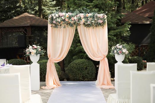 Beautiful wedding arch for an exit ceremony with flowers.