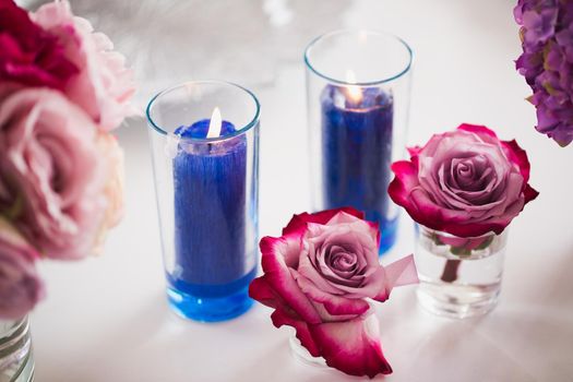 Brightly decorated wedding decor. Beautiful flowers and burning candles